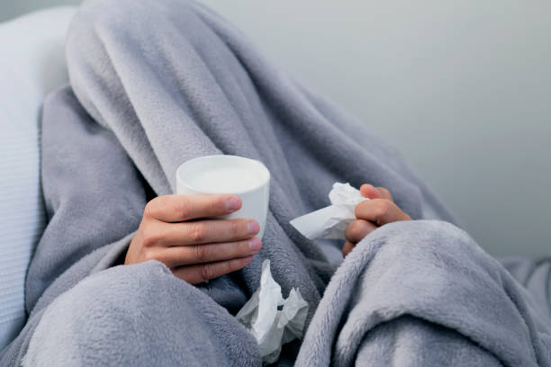 istock ill man warming up with a cup of hot milk 1127734467