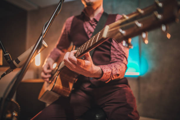istock Rock musician singing and playing acoustic guitar 1127734564