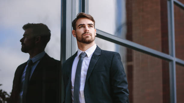 istock Businessman standing outside and looking away 1127734838