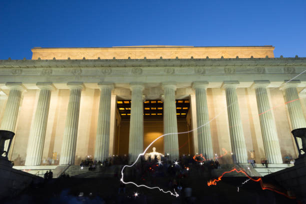 langzeitbelichtung szene an der abraham lincoln memorial in washington, d.c., mit taschenlampen von touristen. über die beleuchteten säulen befindet sich ein fries mit reliefs von einigen staaten. - usa presidents flash stock-fotos und bilder