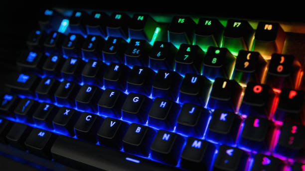 istock Backlit keyboard with rainbow colors - Blue, orange, green, pink 1127735269