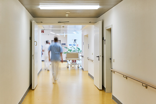 Hospital with corridor bed doctor nurse and with persons and motion blur