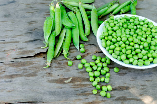 istock Pods of young green peas and pea 1127737726