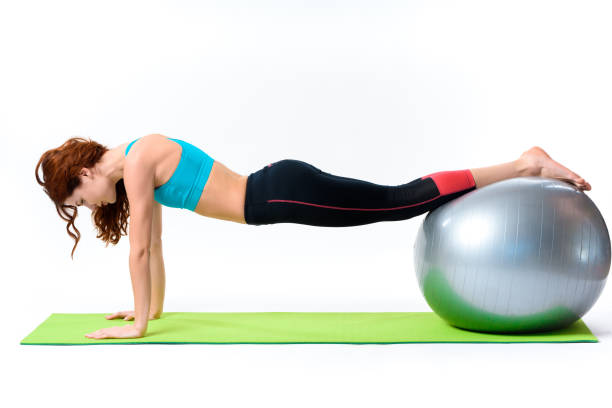 istock Girl Is Doing Push Up Exercises With Gym Ball. 1127738170