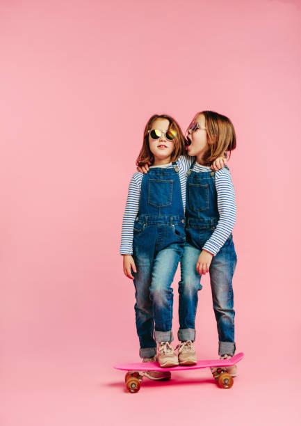 istock Twin girls together with skateboard 1127738640