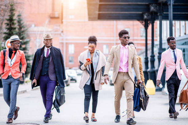 istock good looking woman is looking at photos while walking with coworkers 1127740496