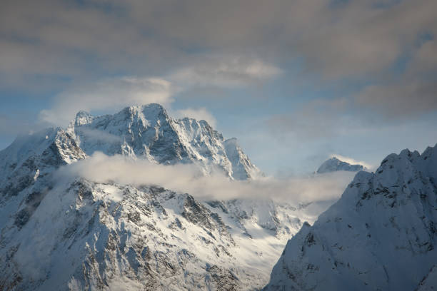 istock snowy mountain peaks in winter day with blue sky in Dombay 1127741781