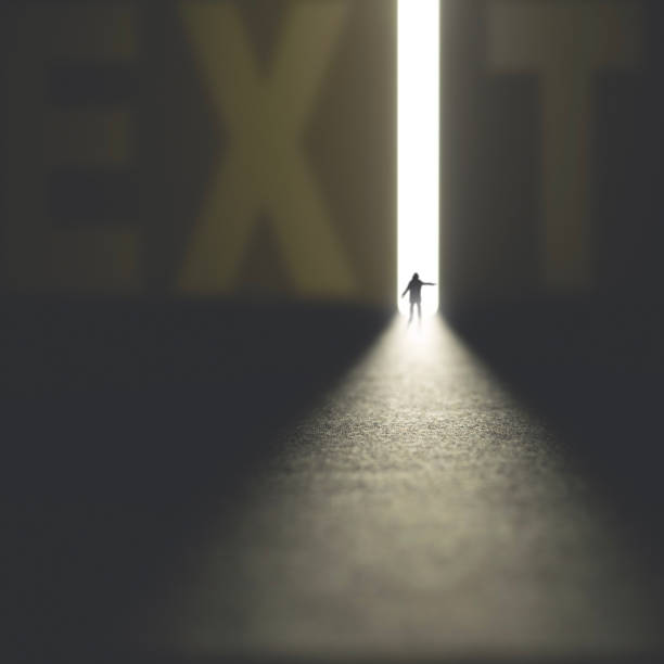istock business man find the way out in the exit signs 1127742616