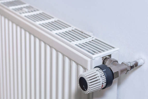 istock Radiator on a wall with thermostat 1127743183