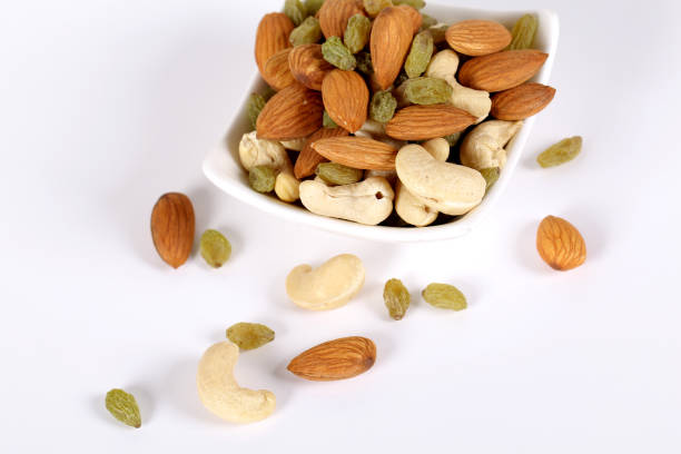 istock Assorted nuts on white, dry fruits, mix nuts, almond, cashew, raisins 1127744596