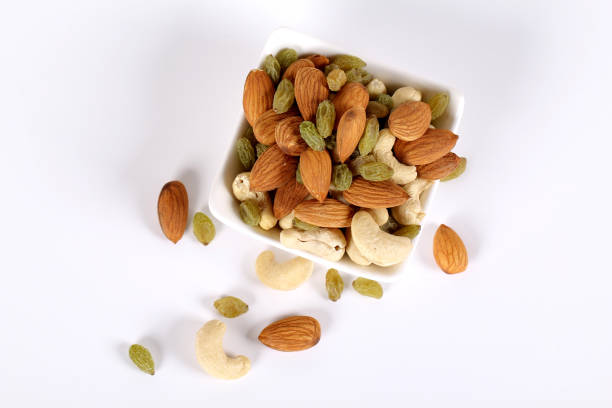 istock Assorted nuts on white, dry fruits, mix nuts, almond, cashew, raisins 1127744664