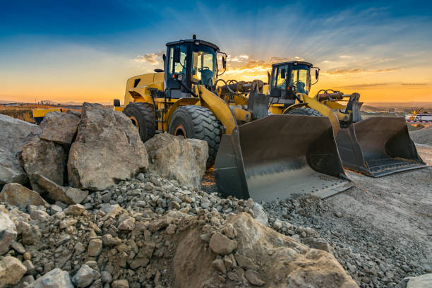 istock Group of excavators in a quarry 1127746829