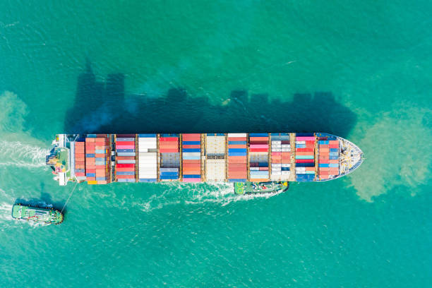 istock Aerial view and top view. Container ship in pier with crane bridge carries out export  and import business in the open sea. Logistics and transportation 1127748036