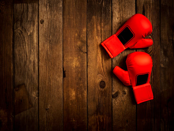 istock Leather karate gloves on the wooden background. Top view 1127748232