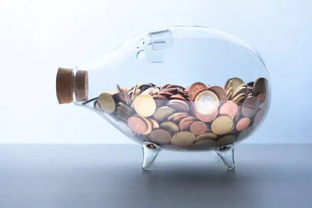Saving concept: Piggy bank filled with euro coins