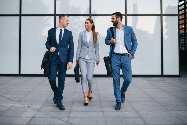 istock Three business colleagues having discussion while walking outdoors 1127751302