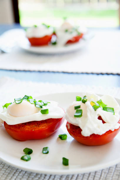istock Hay diet recipe - poached eggs on tomatoes. Healthy eating version of egg Benedict - only eggs and vegetables. 1127751814