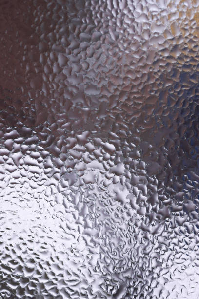 istock Water drops on glass window close up with blurred background. Drops in macro. Condensate on window closeup. Wet air. 1127754077