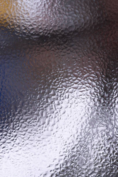 istock Water drops on glass window close up with blurred background. Drops in macro. Condensate on window closeup. Wet air. 1127754086