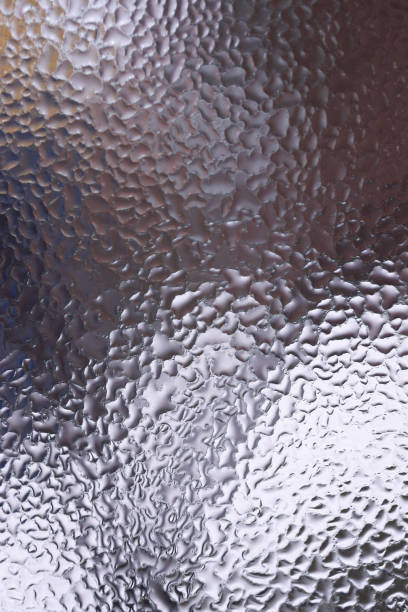 istock Water drops on glass window close up with blurred background. Drops in macro. Condensate on window closeup. Wet air. 1127754091