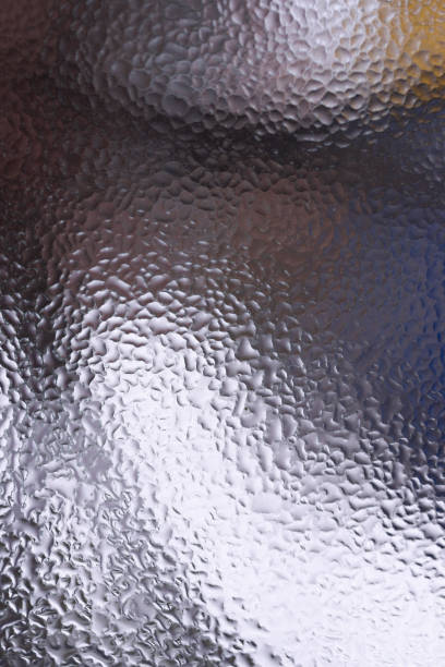 istock Water drops on glass window close up with blurred background. Drops in macro. Condensate on window closeup. Wet air. 1127754096