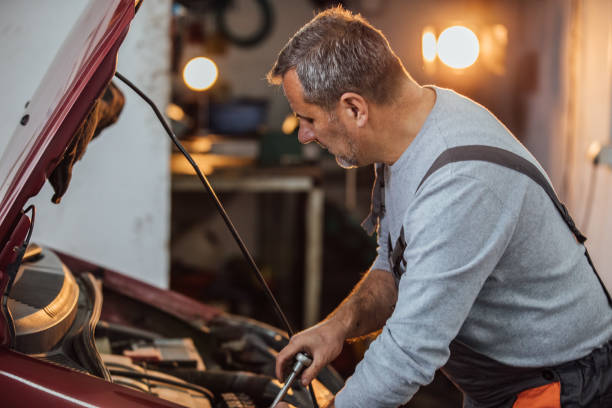 istock Car mechanic repairing a vehicle in workshop 1127758385