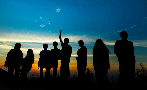 istock Silhouette People Standing Against Sky During Sunset 1127764662
