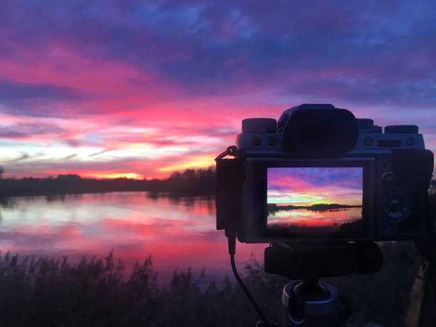 Photographing the sunset at the river IJssel during springtime with a camera mounted on a tripod.