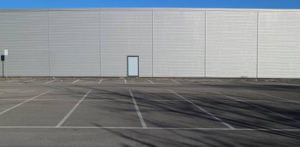 istock Urban background and copy space. Empty parking in front of an aluminium cladding modern building 1127765307