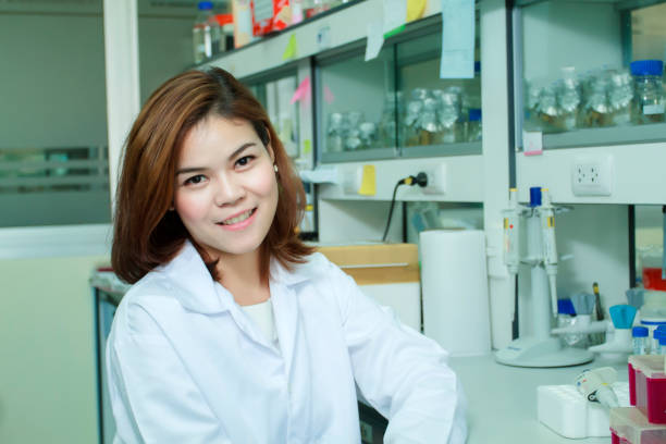 istock Portrait Of Smiling Young Scientist Sitting At Laboratory 1127765372