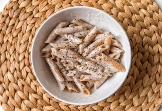 Italian penne pasta with cream cheese and black pepper