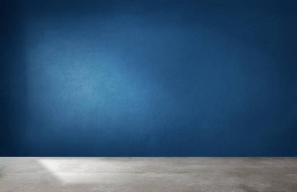 istock Dark blue wall in an empty room with a concrete floor 1127768802