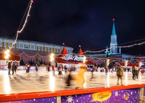 Famous skating rink on Red square near GUM (Main department store). Walking people, shooting with long-exposure. Moscow, Russia - December 03, 2017. Famous skating rink on Red square near GUM (Main department store). Walking people, shooting with long-exposure. long exposure winter crowd blurred motion stock pictures, royalty-free photos & images
