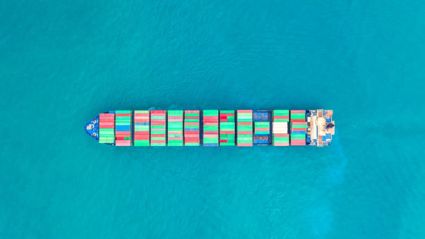 istock Container ship in export and import business logistics and transportation. Cargo and container box shipping to harbor by crane. Water transport International. Aerial view and top view. 1127769649