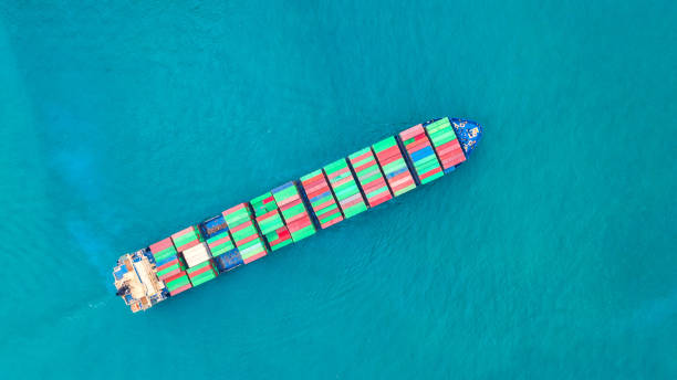 istock Container ship in export and import business logistics and transportation. Cargo and container box shipping to harbor by crane. Water transport International. Aerial view and top view. 1127769665