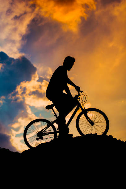 istock Cycling at dusk blue sunset sky color. 1127771419