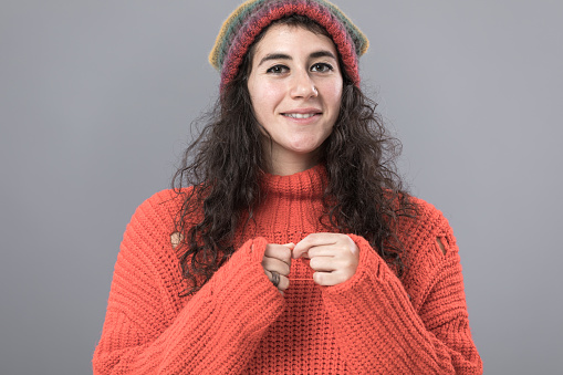 Wearing knitted hat, sweater