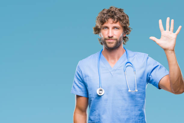 istock Handsome hispanic surgeon doctor man over isolated background showing and pointing up with fingers number five while smiling confident and happy. 1127775431