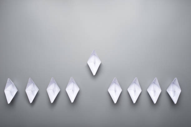 istock Nine paper made origami boats over grey background 1127775560