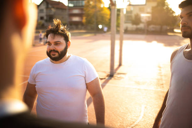 istock Overweight Man On Basketball Court 1127776320