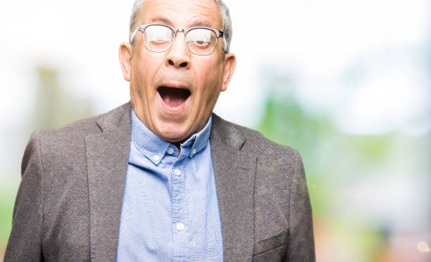 istock Handsome senior businesss man wearing glasses afraid and shocked with surprise expression, fear and excited face. 1127776979