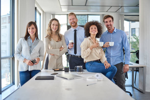 Cheerful group of business people posing in office. stock photo