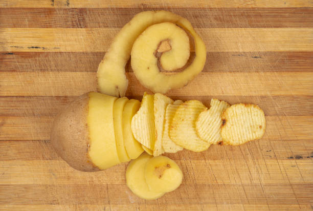 istock Yellow potato with Chips on wooden table 1127778585