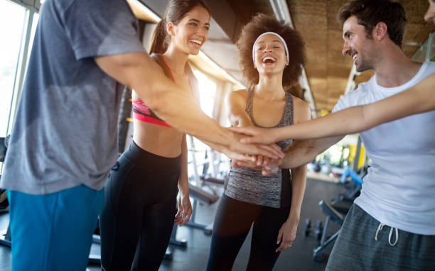 istock Group of young people doing exercises in gym 1127778966