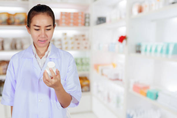 istock Mid Adult Pharmacist Holding Bottle While Standing In Store 1127779622