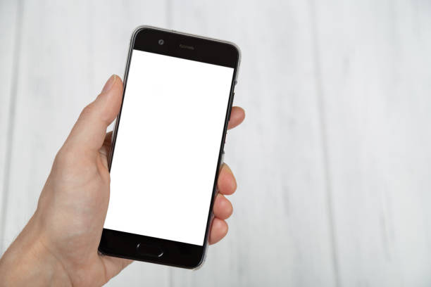 Hand holding smartphone with empty screen. Mockup. stock photo