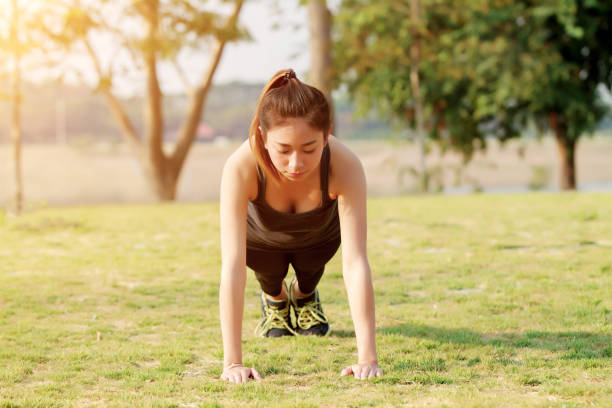 istock Young Woman Doing Yoga In Park 1127781809