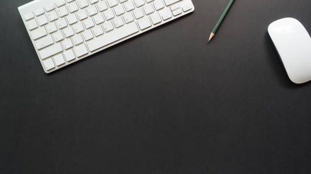 istock workspace desk with keyboard and pencil copy space background  black 1127783824