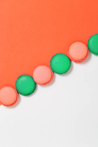 istock Sweet colorful macaroons in row. Bright macaroon biscuits close up on paper background. Top view. 1127784506