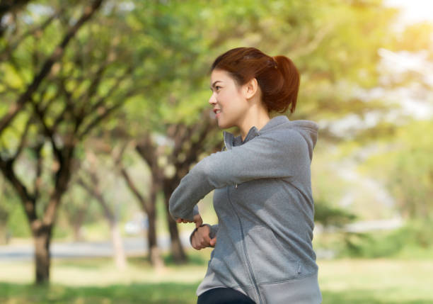 istock Smiling Young Woman Exercising Outdoors 1127784955